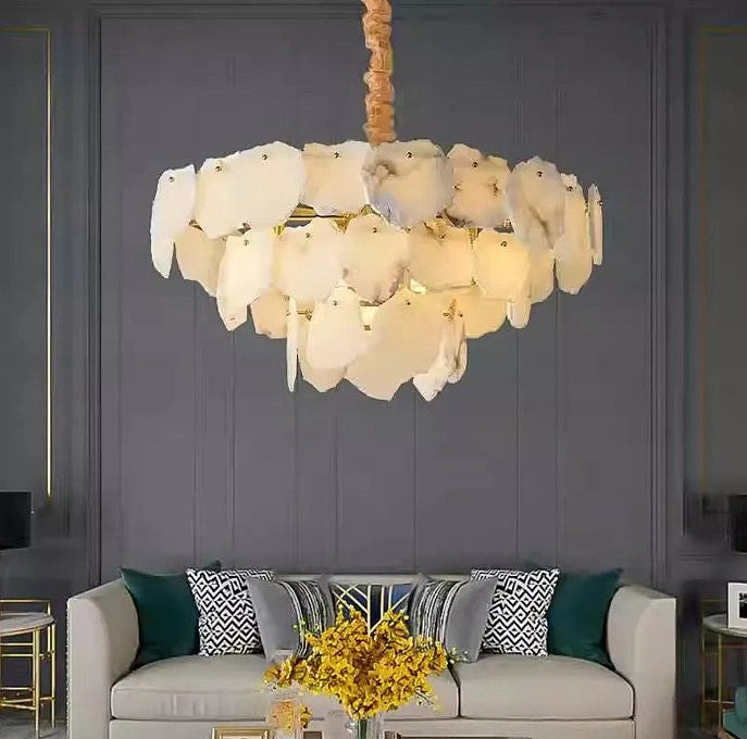 Organic modern alabaster chandelier above a sofa in a moody luxury living room - L&B