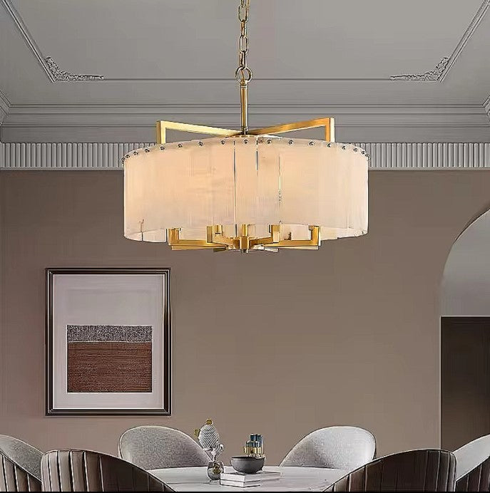 Alabaster dining room chandelier above a round table in a warm contemporary interior - L&B
