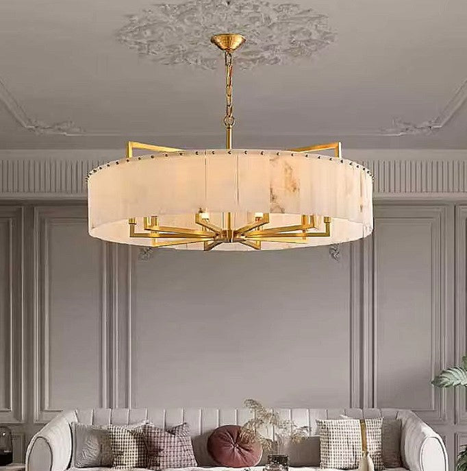 Large alabaster drum chandelier above a living room sofa in a transitional interior - L&B