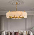 Large alabaster drum chandelier above a living room sofa in a transitional interior - L&B