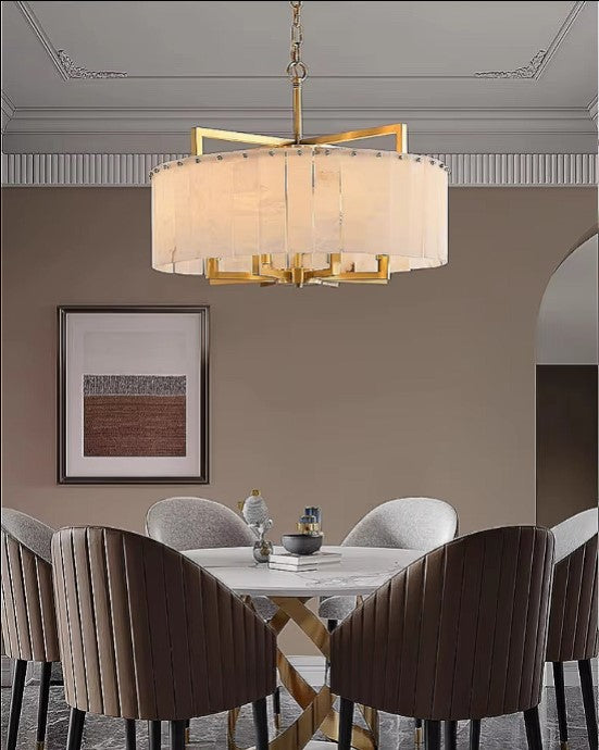 Alabaster chandelier above a round dining table in a modern transitional dining room - L&B