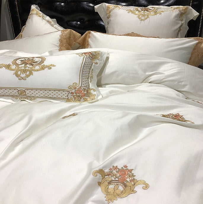 Close-up of champagne gold floral motifs on ivory Egyptian cotton bedding, STONGE ROYAL – L&B