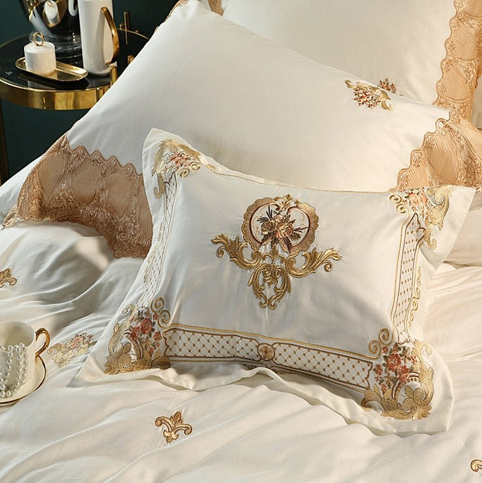 Close-up of ivory pillow shams with champagne gold royal embroidery and lace trim, STONGE ROYAL – L&B