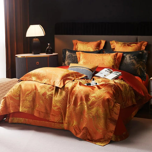 Luxury burnt orange bedding set styled with a jacquard duvet cover, matching pillow shams, and black accent cushions – L&B