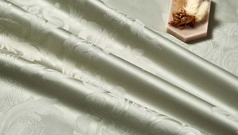 Close-up of smooth sage green Egyptian cotton satin fabric with a soft drape and subtle luminous sheen – L&B