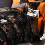 Luxury black and gold duvet cover set styled with layered shams, burnt orange pillows, and elegant bedside details – L&B