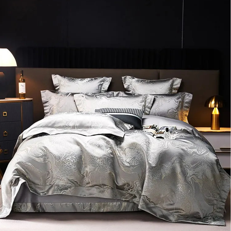 Silver gray jacquard duvet cover set with platinum threadwork, layered pillows, and a luminous finish in a modern bedroom – L&B