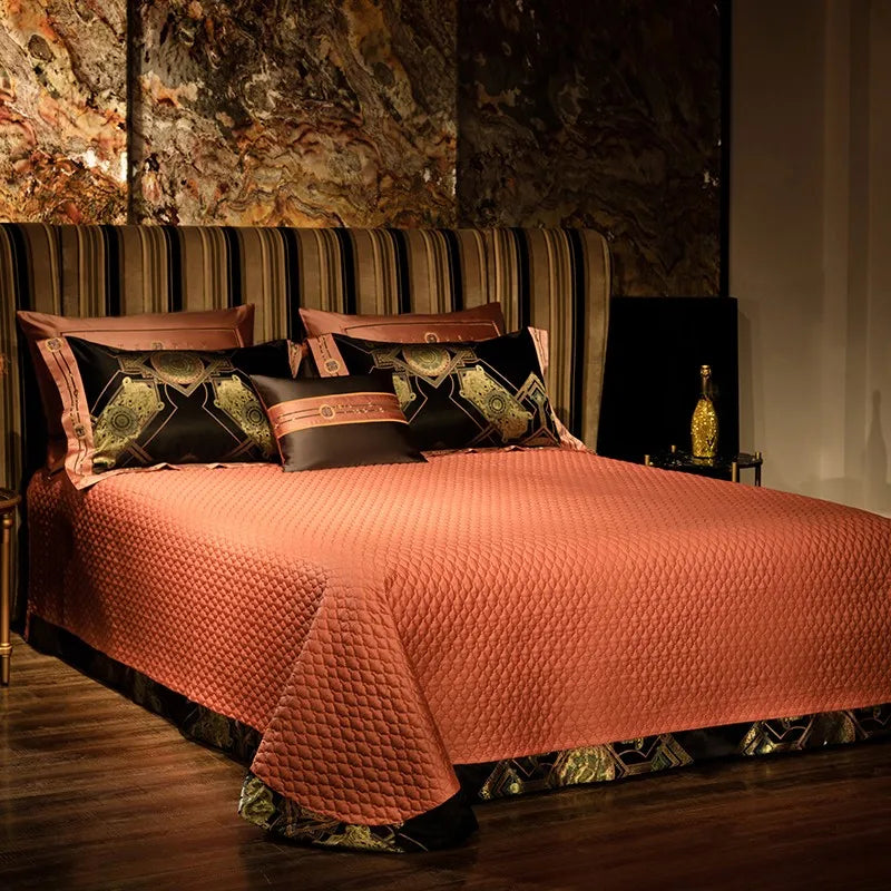 Textured copper quilted bedspread styled with black and gold baroque pillow shams – ROYAL H. BLACK – L&B