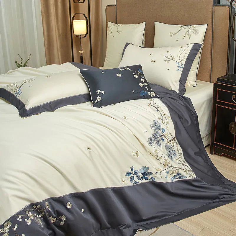 Close-up of blue and ivory floral embroidery along the deep gray border of an Egyptian cotton duvet cover – L&B