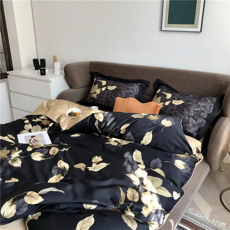 Black and gold leaf duvet cover set styled with coordinating pillows and beige reverse – L&B
