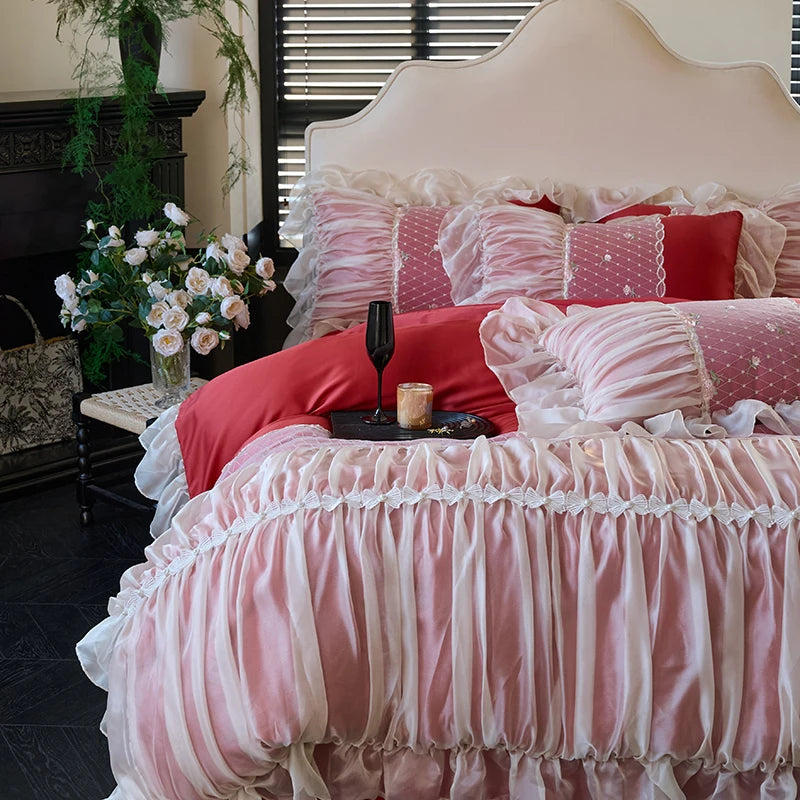 Red princess duvet cover with pink and white cascading lace ruffles, angled view of RUBYLACE RED – L&B