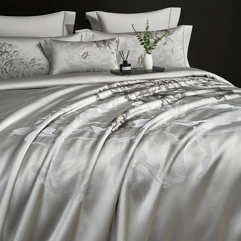 Luxury silver gray satin bedding showing a floral jacquard pattern and fluid drape, SILVIORA – L&B