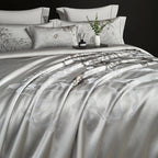 Luxury silver gray satin bedding showing a floral jacquard pattern and fluid drape, SILVIORA – L&B