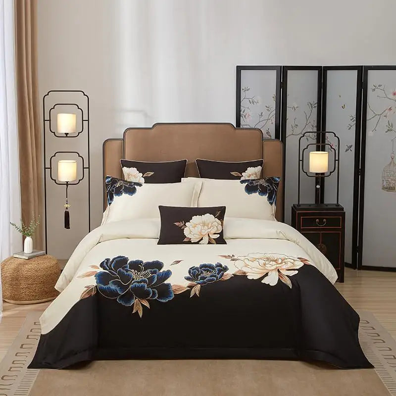 Black and ivory floral duvet cover set with blue peony embroidery displayed in a modern bedroom – L&B