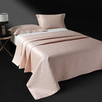 Blush pink quilted bedspread layered over a floral jacquard duvet cover, LUSTRA BLUSH – L&B