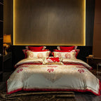 Red floral bedding set styled with an ivory embroidered duvet cover and coordinating decorative pillow shams – L&B