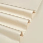 Close-up of layered ivory Egyptian cotton fabric showing its refined weave and softly tailored finish – L&B