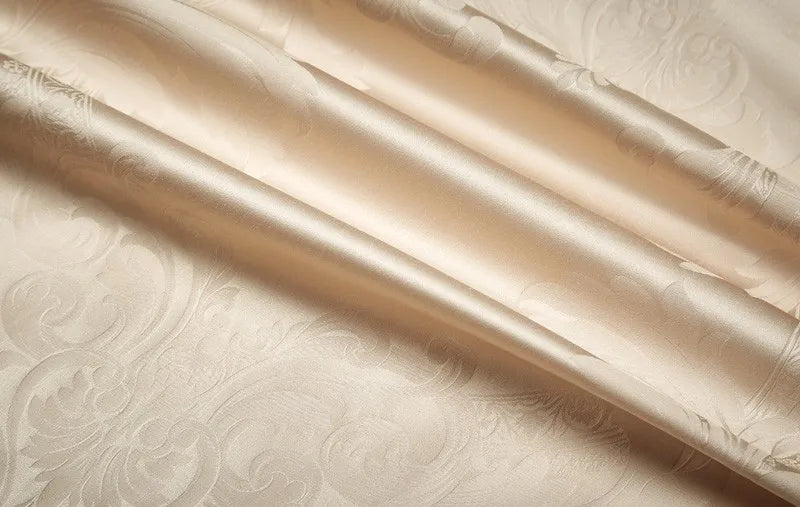 Close-up of smooth gold 1200TC Egyptian cotton satin fabric with luminous folds and silky luster - L&B