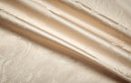 Close-up of smooth gold 1200TC Egyptian cotton satin fabric with luminous folds and silky luster - L&B