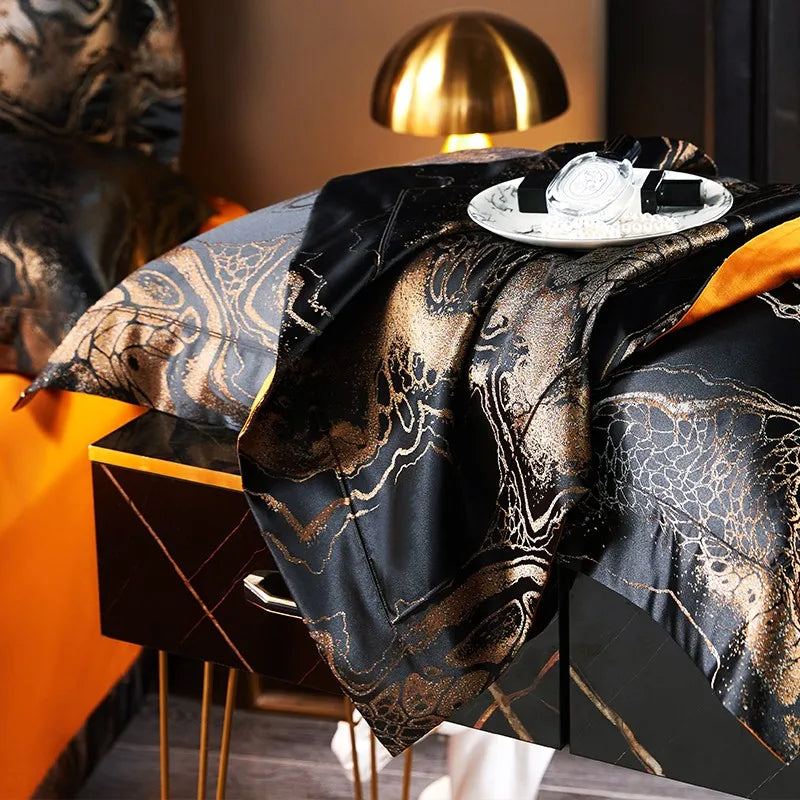 Side view of a black gold satin jacquard duvet cover with flowing drape and vivid burnt orange contrast – L&B