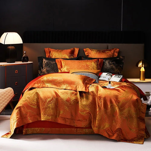 Burnt orange jacquard duvet cover set with ornate damask pattern and layered pillows in a luxury modern bedroom – L&B