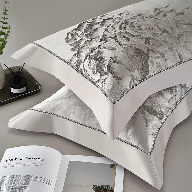 Silver gray floral jacquard pillow shams layered with satin bedding, SILVIORA – L&B