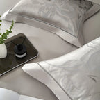 Close-up of silver gray floral jacquard pillow sham and satin duvet cover, SILVIORA – L&B