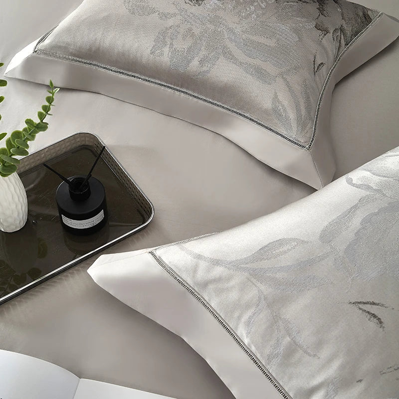 Close-up of silver gray floral jacquard pillow sham and satin duvet cover, SILVIORA – L&B