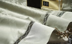 Coordinating sage green pillow shams with damask detailing, braided trim, and a lustrous satin finish – L&B
