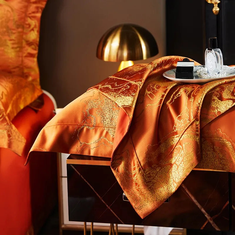 Side view of a luxury burnt orange bedding set with the jacquard duvet draped over a contemporary bed frame – L&B