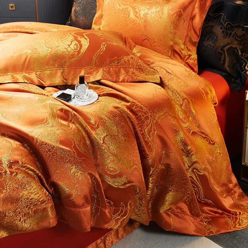 Close-up of a burnt orange jacquard duvet cover with flowing drape, ornate damask weave, and luminous copper-gold finish – L&B