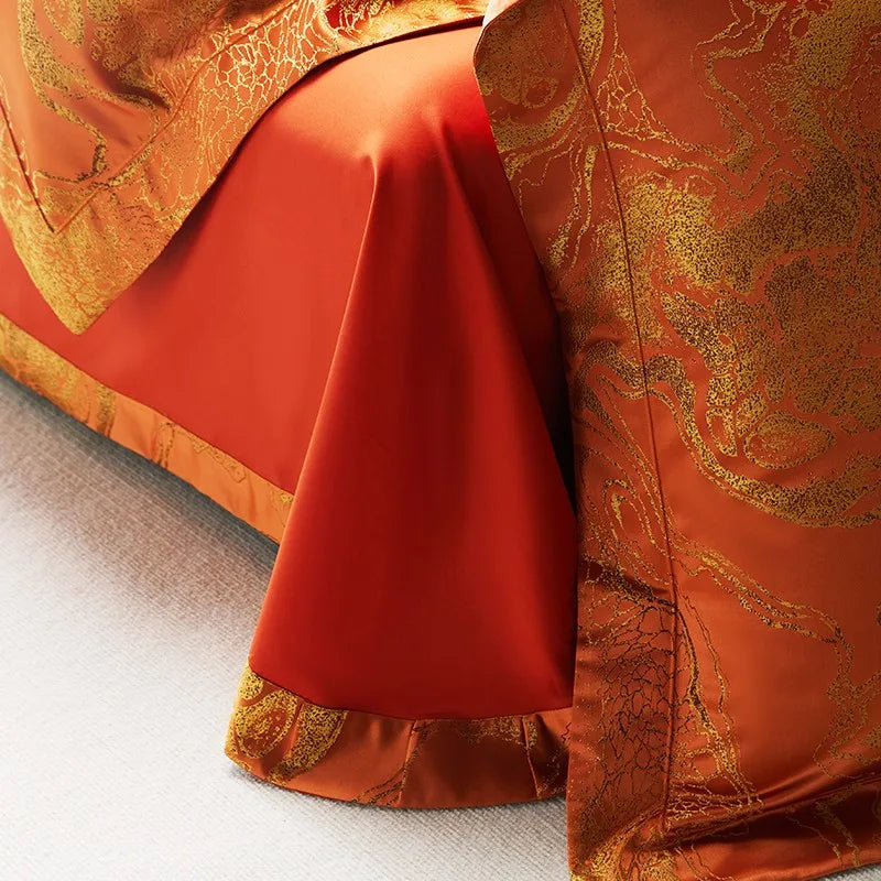 Close-up of rust orange jacquard duvet cover with an ornamental woven motif and solid red reverse fabric – L&B