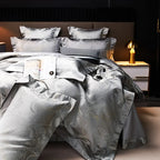 Luxury silver duvet cover set with dragon and cloud-inspired jacquard motifs, matching shams, and a graceful drape – L&B
