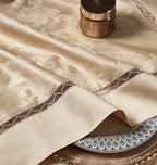 Close-up of tonal braided trim and piping on the gold Egyptian cotton satin duvet cover - L&B