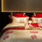 Red floral bedding with layered embroidered pillows and an ivory Egyptian cotton satin duvet cover – L&B