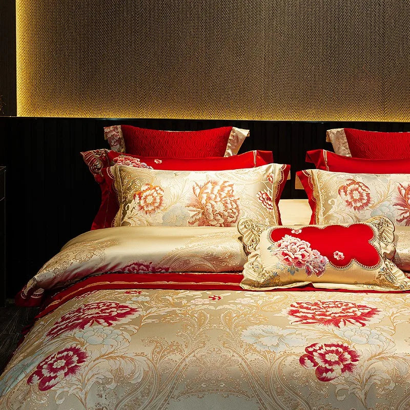 Red floral bedding with layered embroidered pillows and an ivory Egyptian cotton satin duvet cover – L&B