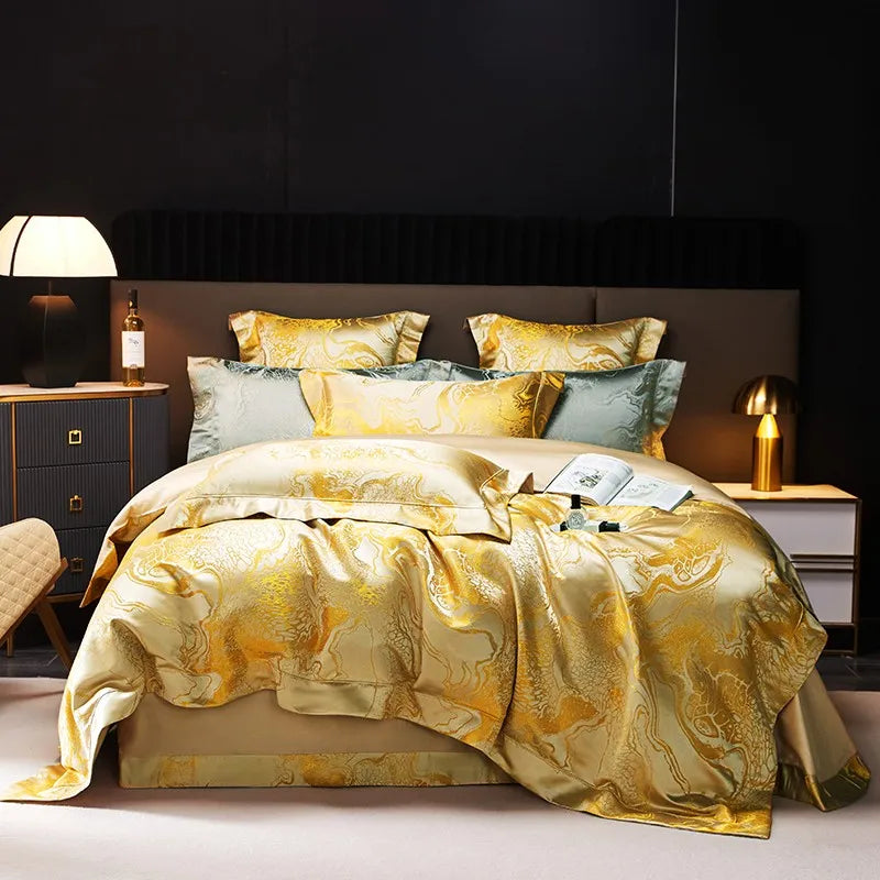 Gold jacquard duvet cover set with a fluid white marble pattern, layered shams, and luminous champagne finish – L&B