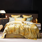 Gold jacquard duvet cover set with a fluid white marble pattern, layered shams, and luminous champagne finish – L&B