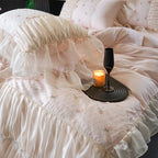 Close view of blush pink heart-quilted bedding with floral embroidery and cascading ruffles, RUBYLACE BLUSH – L&B