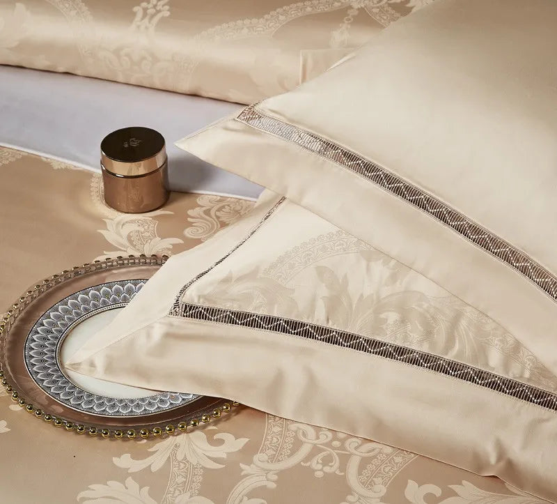 Champagne gold pillow shams with tonal braided trim and a smooth satin jacquard finish - L&B