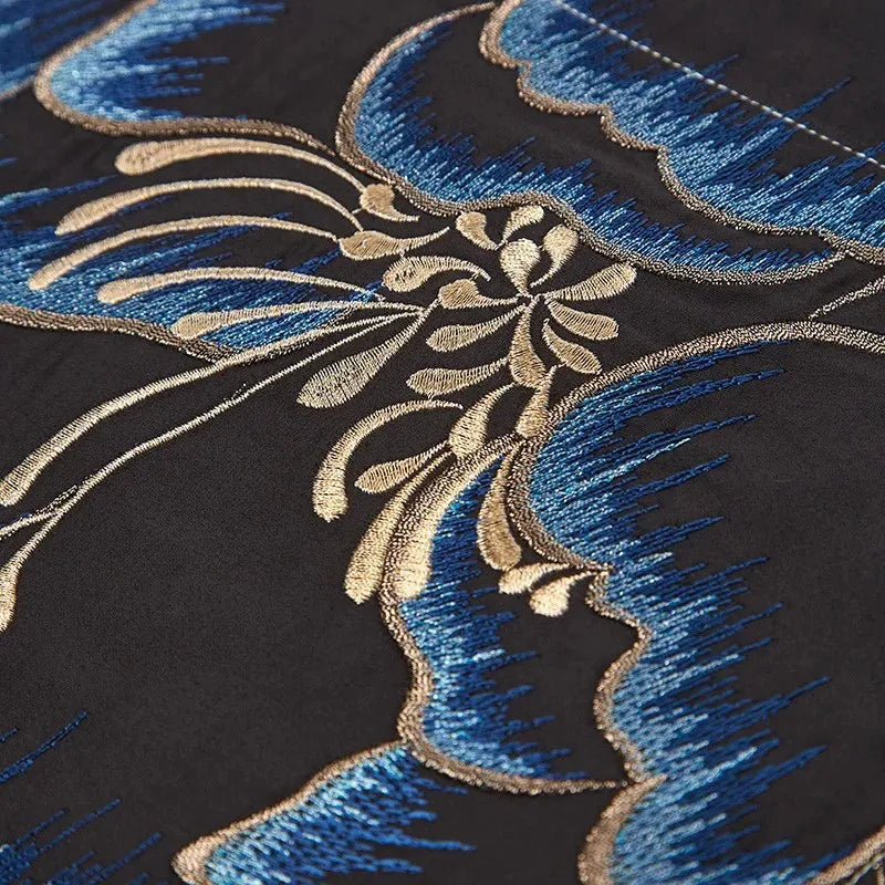 Close-up of blue and gold peony embroidery on black Egyptian cotton bedding with intricate stitched detailing – L&B