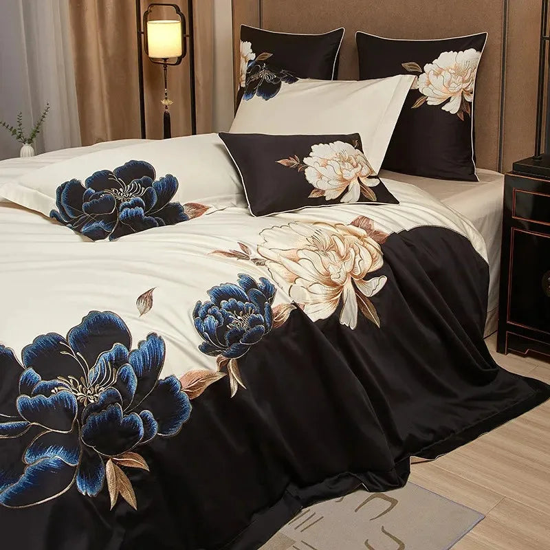 Black and ivory embroidered duvet cover set styled with blue floral detailing and coordinating pillow shams – L&B