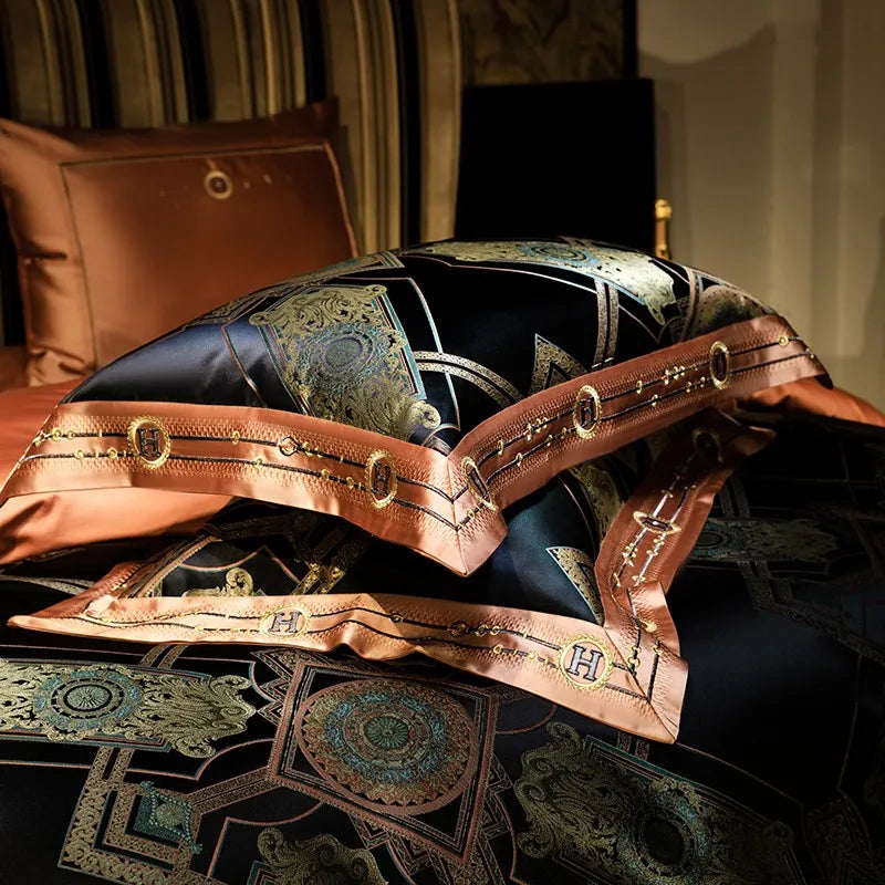 Close-up of black and gold jacquard bedding with layered copper satin trim and braided detailing – ROYAL H. BLACK – L&B