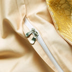 Close-up of the concealed zipper closure on the smooth champagne reverse side of the gold duvet cover – L&B