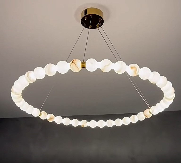Large alabaster globe ring chandelier with illuminated natural stone spheres and a brass canopy – AURELIA
