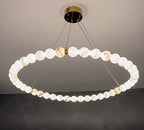 Large alabaster globe ring chandelier with illuminated natural stone spheres and a brass canopy – AURELIA