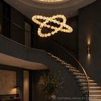 Modern alabaster statement chandelier in a foyer with a curved staircase - L&B